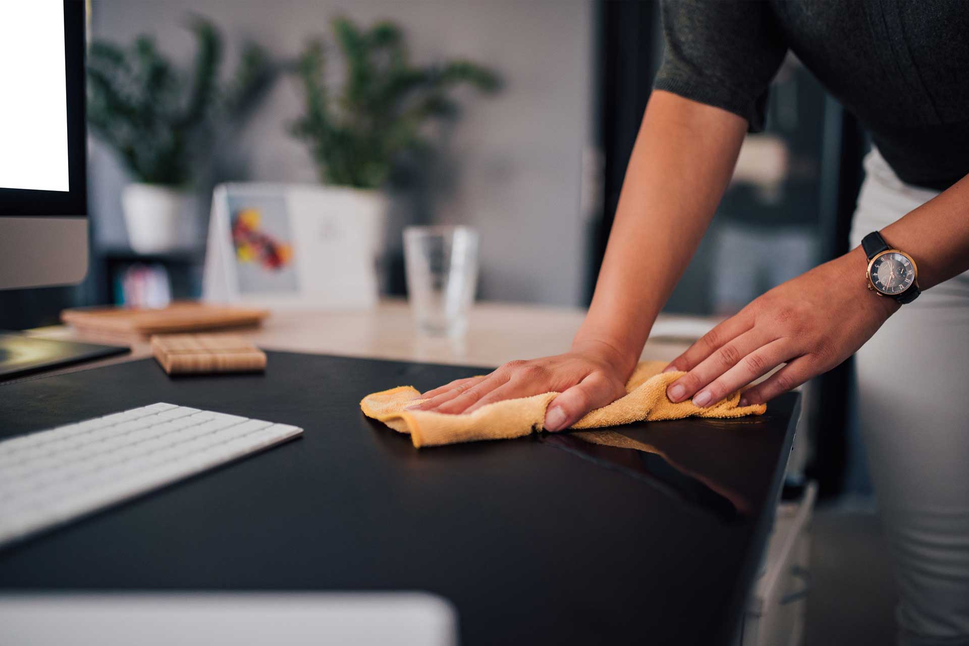 man cleaning office desk